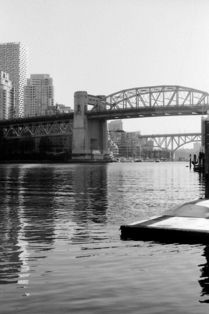 B&W photo of False Creek with Burrard and Granville Bridges